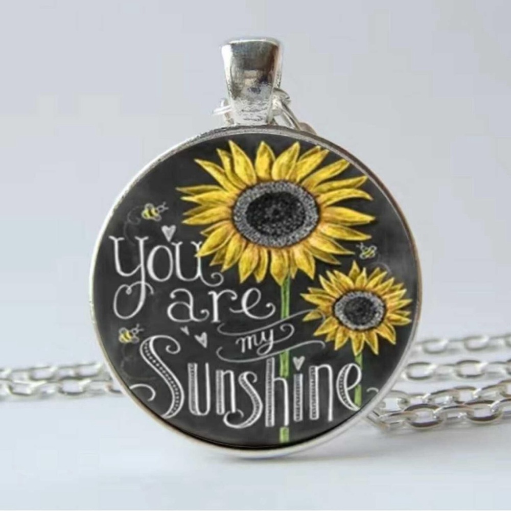 NWT “You Are My Sunshine” pendant on a silver chain.